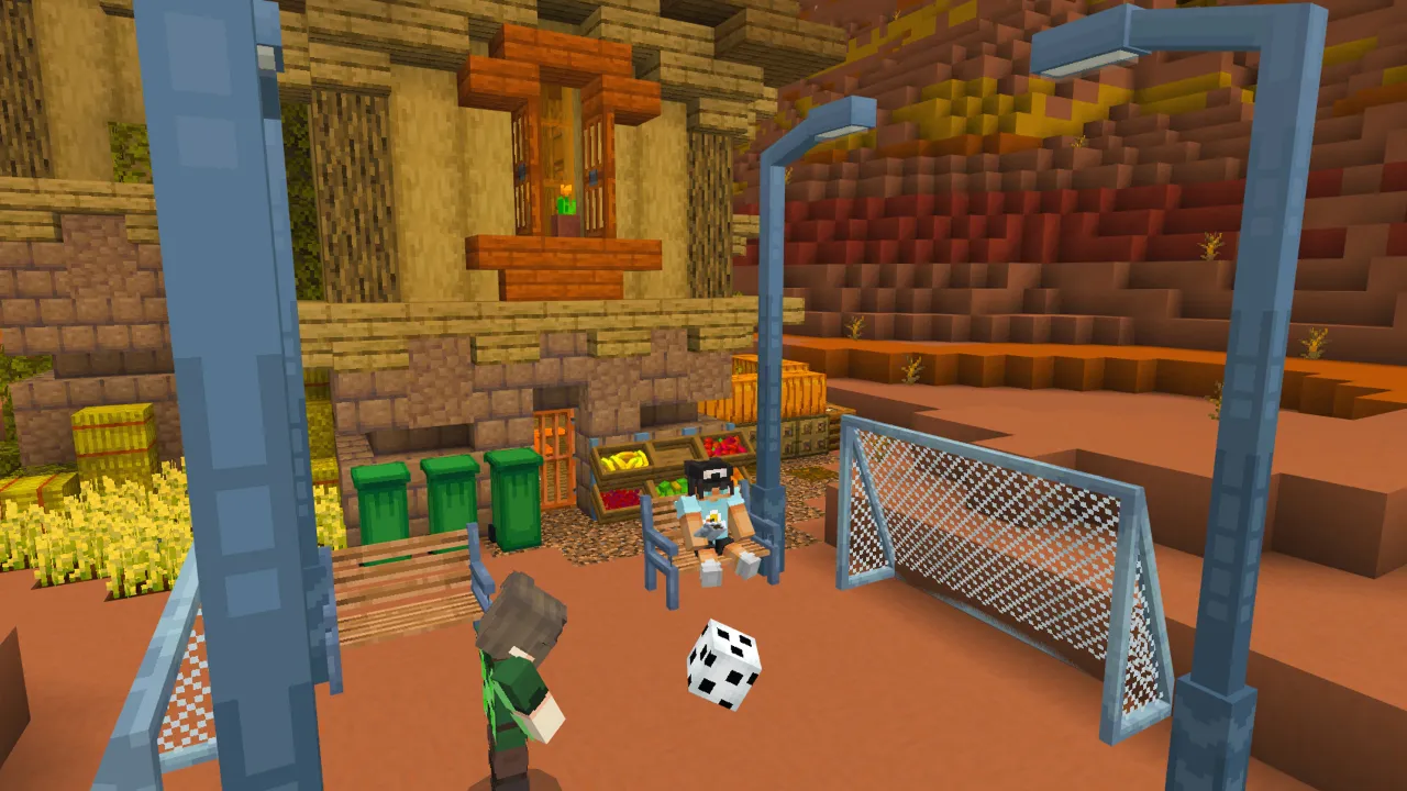 Minecraft Bedrock players playing soccer near a goal net in a stadium setting in the Furniture Pack add-on