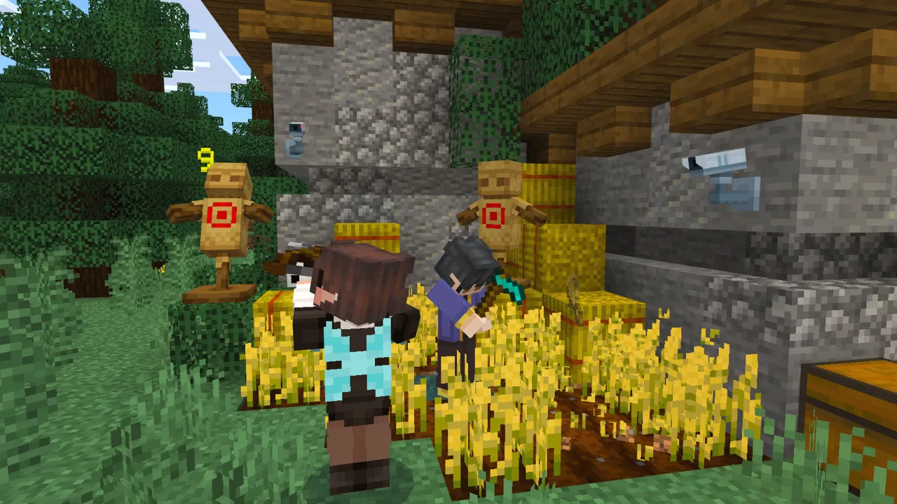 Minecraft Bedrock players standing near a wheat farm and hay bales in the Furniture Pack add-on