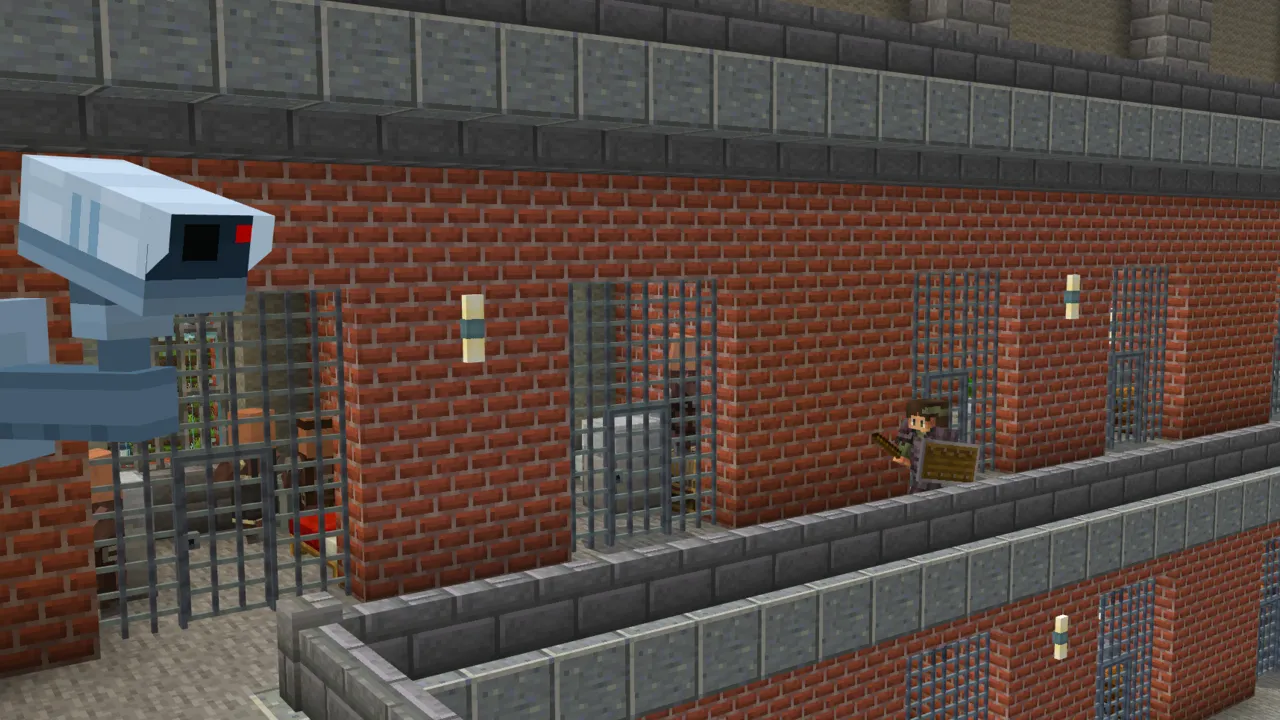 Brick prison exterior with barred windows and a security camera mounted on the wall in the Ultimate Police Base Minecraft Bedrock add-on