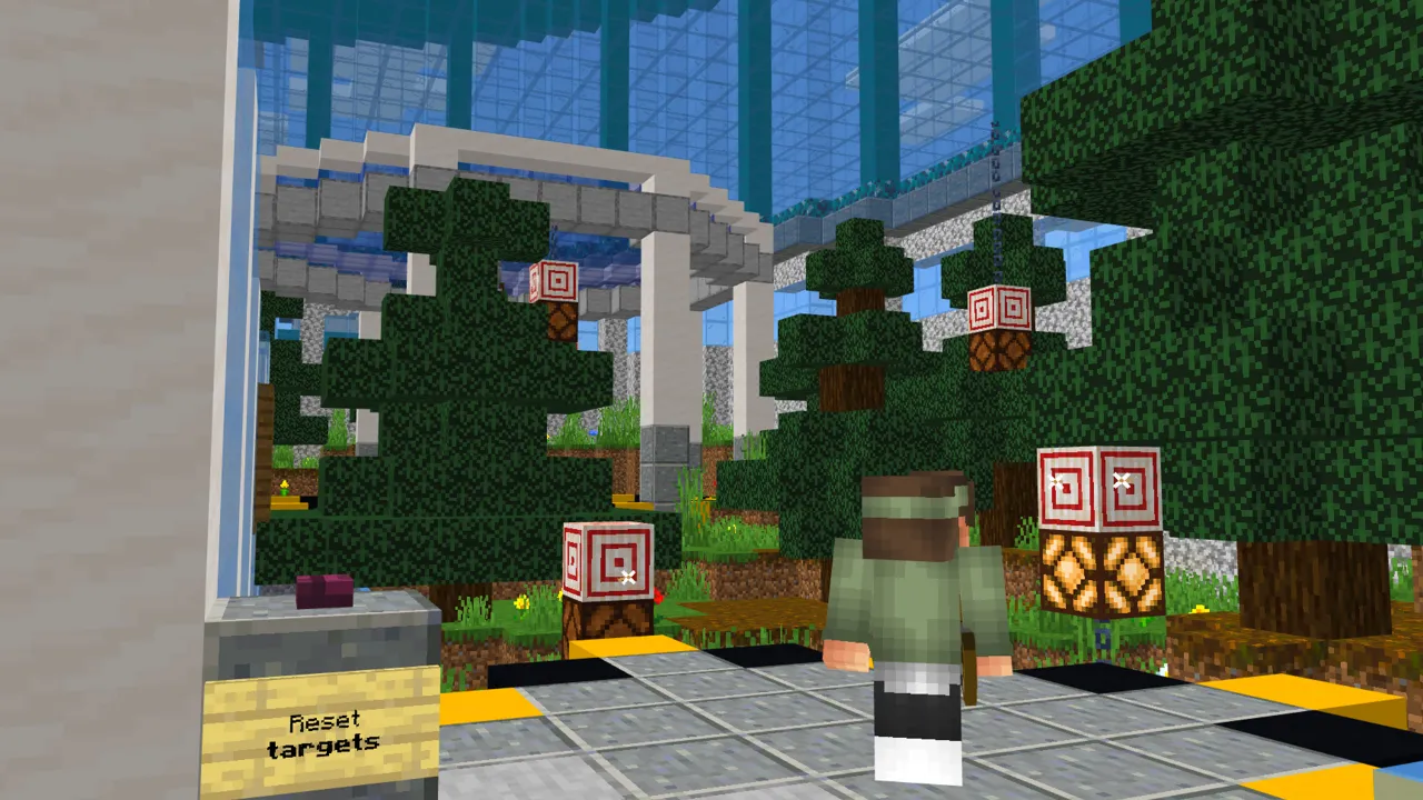 Minecraft Bedrock player standing near warning signs in an outdoor courtyard in the Ultimate Security Pack map