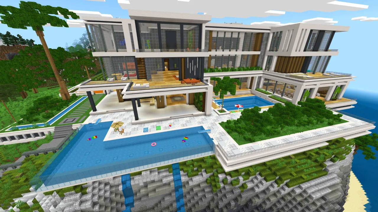 Aerial view of a realistic modern mansion with a pool and multiple levels in Minecraft Bedrock.